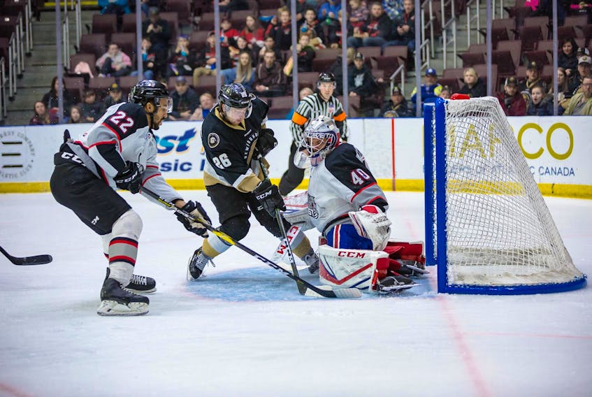 Josh Kestner of the Newfoundland Growlers looks to slam a rebound past Brampton Beast goaltender Etienne Marcoux as Beast defenceman Matt Petgrave tries to intervene during ECHL playoff action Tuesday night at Mile One Centre. The Growlers won 3-2 in overtime to advance to the next round.