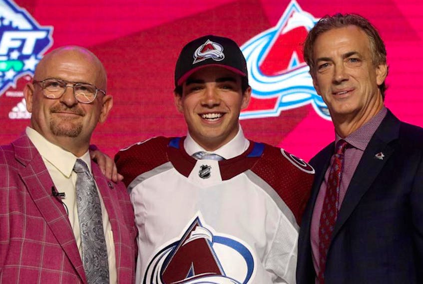 Alex Newhook is flanked by Colorado Avalanche general manager Joe Sakic (right) and director of amateur scouting Alan Hepple after the Avalanche made Newhook a pick in the first round of Friday’s NHL Entry Draft in Vancouver — Colorado Avalanche/Twitter
