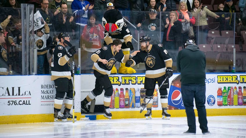 Newfoundland Growlers photo/Joe Chase - Sam Jardine of the Newfoundland Growlers is greeted by teammates James Melindy (43) and Alex Gudbranson as he skates out to acknowledge his second-star selection after scoring the series-clinching goal in overtime against the Brampton Beast Tuesday night at Mile One Centre.