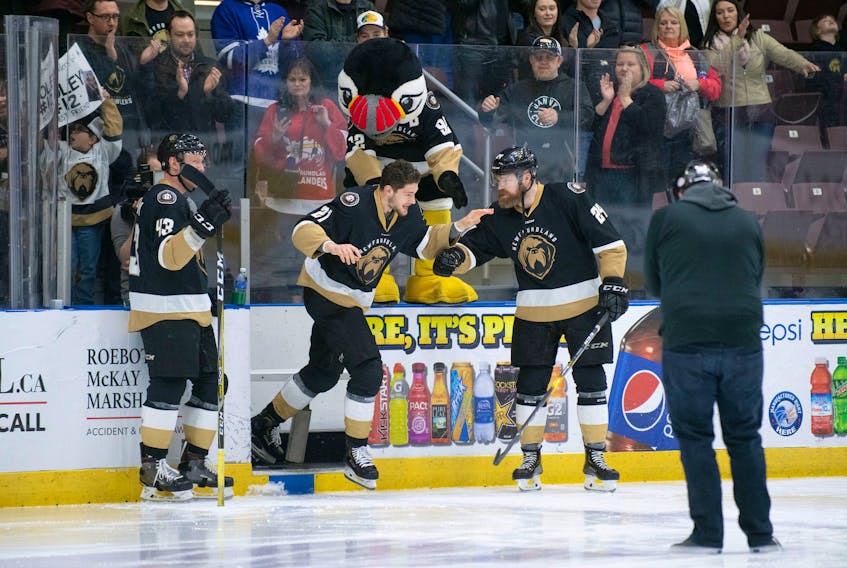 Newfoundland Growlers photo/Joe Chase - Sam Jardine of the Newfoundland Growlers is greeted by teammates James Melindy (43) and Alex Gudbranson as he skates out to acknowledge his second-star selection after scoring the series-clinching goal in overtime against the Brampton Beast Tuesday night at Mile One Centre.