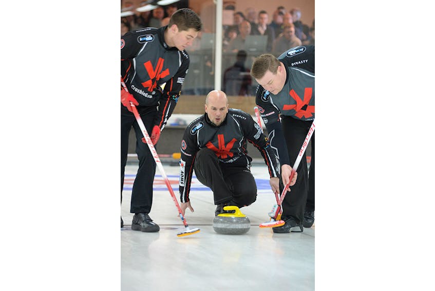 Andrew Symonds delivers a rock as sweepers Chris Ford, left, and Keith Jewer prepare to sweep during the final of the provincial Tankard men’s curling championship last month. Symonds and his team from the Remax Centre (St. John’s Curling Club) open the 2019 Tim Hortons Brier Saturday.