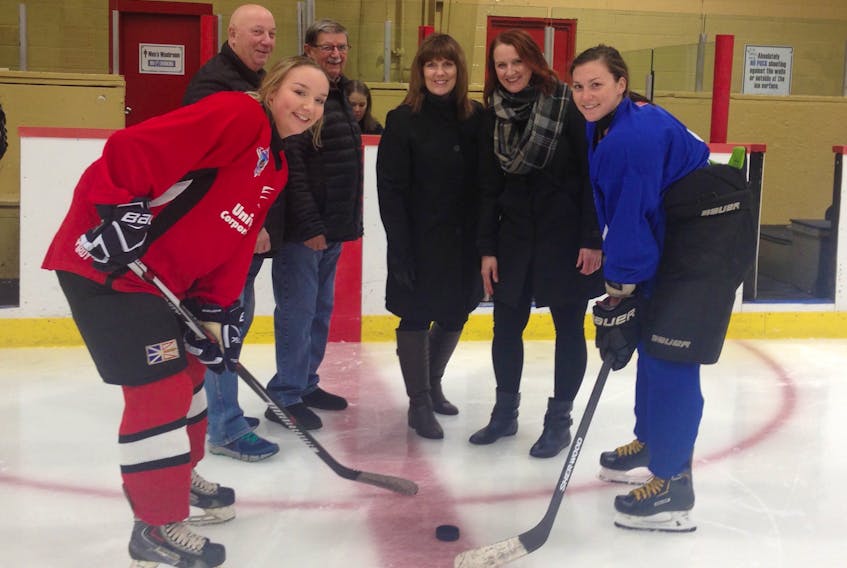 Sarah Murphy (left) foreground of Universal Corporate Wear and Emily Bailey of the Blizzard take the first official face-off for the Eastern Junior Women’s Hockey League, with participants including (from left) Ed O’Brien (Hockey NL Minor Council), Charlie Kearsey (Junior Council), Denise Fagan (Female Council Eastern Area coordinator) and Debbie Bouzane (Female Council chair).