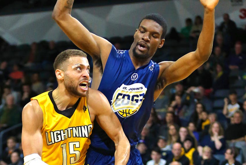 Mike Hensen/London Free Press — Xavier Ford of the St. John’s Edge defends against the London Lightning’s Garrett Williamson during play in Game 6 of their National Basketball League of Canada playoff series Sunday in London, Ont. The Edge were ousted with a 106-101 loss.