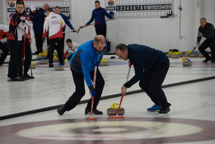 Ken Peddigrew and Craig Dowden, the front end for Frank O'Driscoll's team, work hard to sweep a rock during a game against Dave Thomas's Port aux Basques rink Tuesday afternoon at the re/Max Centre in St. John's, site of the 2018 Tankard provincial men's curling championship.
The O'Driscoll team, which also includes Rick Rowsell, won the game 10-2. Every member of the O'Driscoll rink has won at least two Tankards, with O'Driscoll, Peddigrew and Roswell all having skipped past provincial champs.