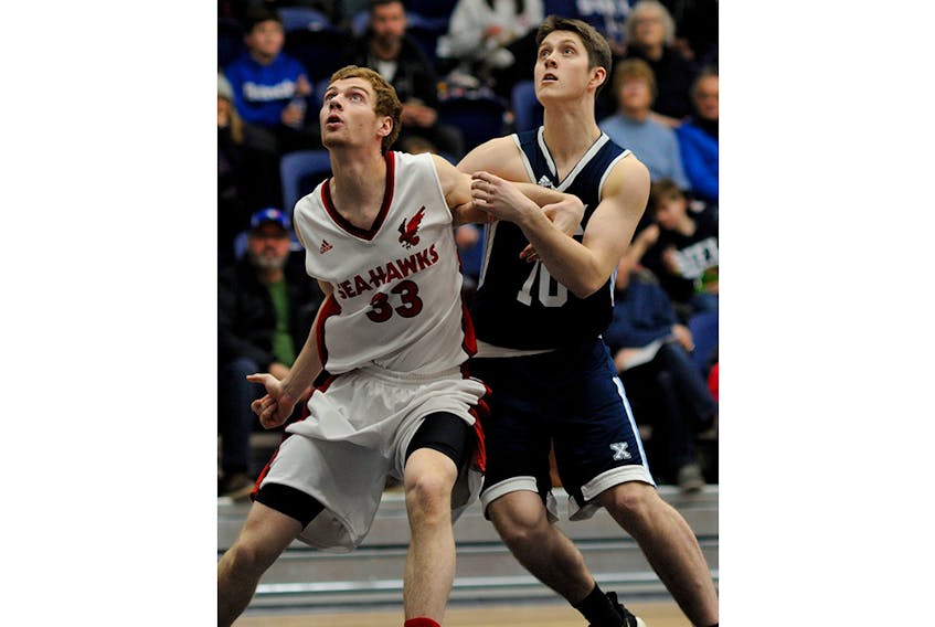 Paddy Dawe of the Memorial Sea-Hawks and Jamie White of the St. Francis Xavier X-Men jockey for position to grab a rebound during AUS men’s basketball play Sunday in Antigonish, N.S. - Bryan Kennedy/St. Francis Xavier
