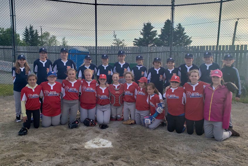 Members of the Phillies and Tigers pose together at home plate at Kilbride Lions Park Monday evening after the first-ever game in A League of Their Own, the all-female baseball league launched by the St. John’s Minor Baseball Association this season. Last year, individual female teams competed in SJMBA rookie, mosquito, peewee and bantam divisions that otherwise featured boys teams. This year, a four-team league comprised of mosquito- and peewee-aged female players was created, with almost 60 registered to play. The Nationals and Rangers are the other teams in A League of Their Own. The Phillies won Monday’s historic contest 3-1.