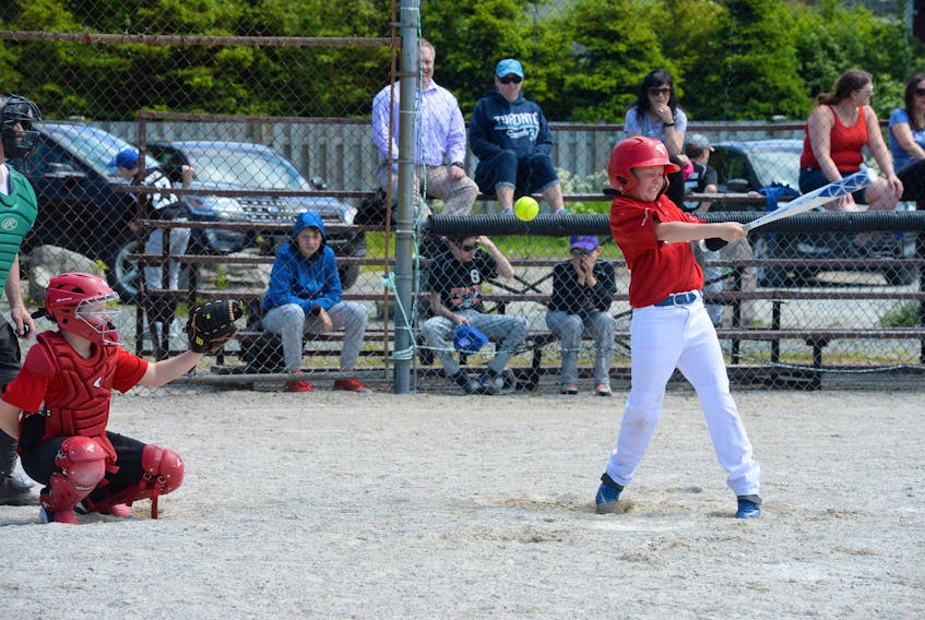 Ben Mercer of the Carbonear Islanders takes a full cut at a pitch from Bay Roberts Rovers pitcher Marcus Dawe (not shown) during their game Tuesday in the boys under-12 division of the 2018 Const. William Moss Memorial Softball Tournament Bill Rahal Field in St. John’s. Action continues in the 38th annual Moss tourney all week in St. John’s, with play in five divisions. — Joe Gibbons/The Telegram