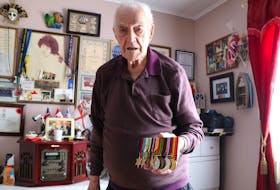 Charles Starkes, 97, of St. John’s displays his Second World War medals in his reading room. Starkes was a torpedo-man on an aircraft carrier that took part in the Allied invasion of occupied France on D-Day, June 6, 1944. He also worked to pull detonators out of mines that had washed ashore on the English coast.
