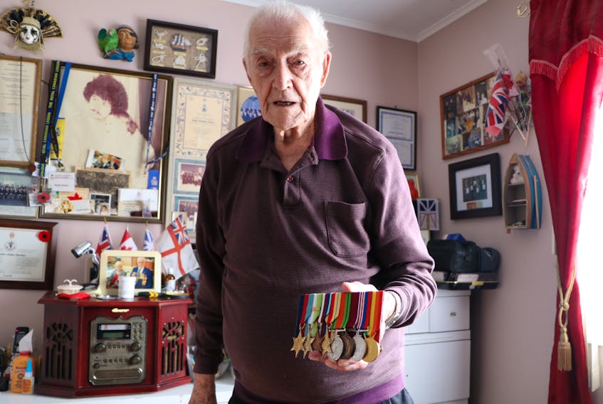 Charles Starkes, 97, of St. John’s displays his Second World War medals in his reading room. Starkes was a torpedo-man on an aircraft carrier that took part in the Allied invasion of occupied France on D-Day, June 6, 1944. He also worked to pull detonators out of mines that had washed ashore on the English coast.