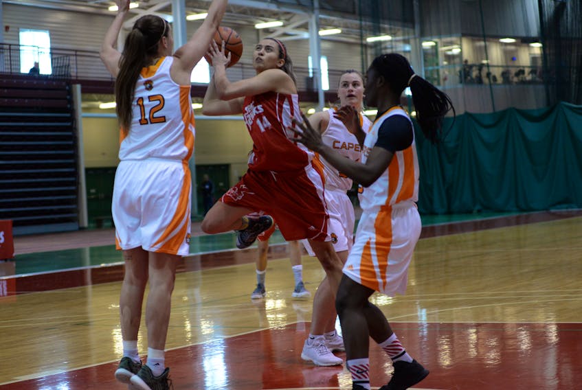 Memorial University Sea-Hawks guard Sydney Stewart (14) goes up for a basket against Cape Breton Capers Alison Keough (12), Hannah Brown (34) and Sandra Amoah (15) during their Atlantic University Sport women’s basketball game at the Memorial Field House on Monday morning. Stewart had a game-high 20 points as Memorial won 84-76.