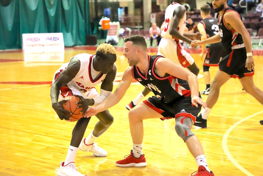 The Memorial Sea-Hawks' Deng Ring (left) looks to move around Daniel Pitcher of the University of New Brunswick Reds during their AUS men's basketball game at the Field House in St. John's last weekend. Ring plays his first regular-season road games with the Sea-Hawks when they take on the Cape Breton Capers today and Sunday in Sydney, N.S. — Memorial Athletics/Dani Ahmad