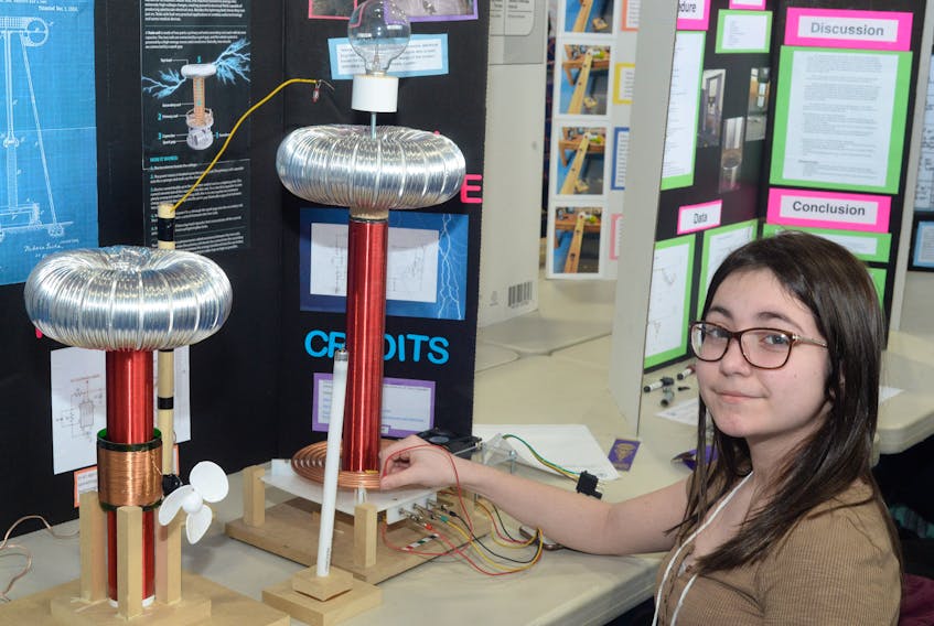 Julia Maunder, 12, a Grade 7 student at MacDonald Drive Junior High School, with her project – The Birth of Wireless Technology – at the Husky Energy Eastern Newfoundland Science and Technology Fair on Friday.