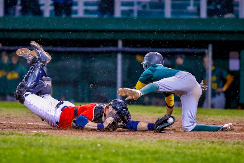David Hiscock/ ActionSnaps.ca - Charlie Kelly of the Shamrocks tried to get around Gonzaga Vikings catcher Gary Dymond to score a run, but was tagged out on the play in Game 7 of the St. John’s Molson Senior Baseball League championship game Sunday night at St. Pat’s Ball Park. The Shamrocks won 4-0 to claim their third straight title.