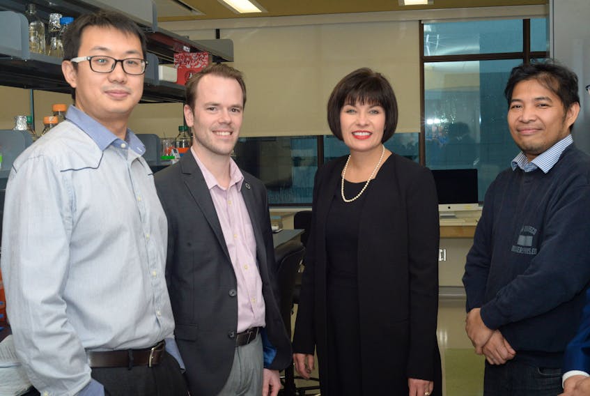 From left, Dr. Dake Qi, Dr. Craig Moore, federal Minister of Health Ginette Petitpas Taylor and Dr. Francis Bambico talk about their projects at the MUN research facility on Wednesday.