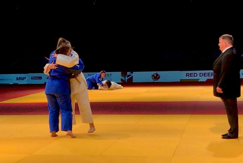 Emma Mullett of St. John’s hugs Gander Natalie Freake (left) after Mullett defeated her provincial teammate in a bronze-medal match in judo at the Canada Winter Games Wednesday in Red Deer, Alta. — Twitter/teamnl