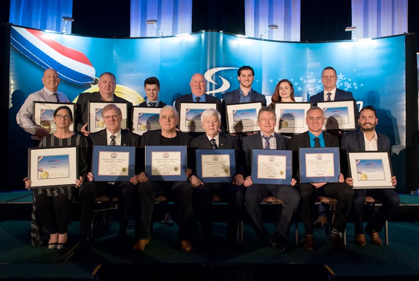 Sport Newfoundland and Labrador handed out its 2018 provincial awards, and the Newfoundland and Labrador Sports Hall of Fame inducted five new members Saturday night. Among the award winners and newest Hall of Famers are, from left, first row: Joan Butler, Bill Hogan, Terry Ryan, Angus Barrett, Wayne Ryder (accepting on behalf of his son, Michael), Ward Gosse, Rekesh Mohan Negi (accepting on behalf of David Liverman); second row: Fintan Gaudette, Blaine Sullivan (accepting on behalf of his daughter, Kate Sullivan), Owen Cumby (accepting on behalf of his brother, Noah Cumby), Ray Gushue (accepting on behalf of his son, Brad Gushue), Jesse Sutton (accepting on behalf of Trevor Budgell), Teri Murphy and Todd Hickey (accepting on behalf of his son,  Liam Hickey). (Photo by Melanie Courage)