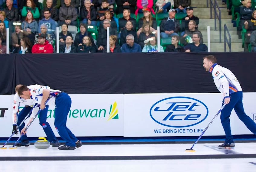 Brad Gushue follows his shot down the ice as his sweepers go to work on the rock during play in the Humpty’s Champions Cup quarter-final against Kevin Koe Saturday in Saskatoon, Sask.