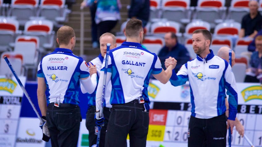 Anil Mungal/World Curling Tour — Members of the Team Gushue curling rink, from left Geoff Walker, Mark Nichols, Brett Gallant and Brad Gushue, clasp hands after winning the Humpty’s Champions Cup in Calgary Sunday.
