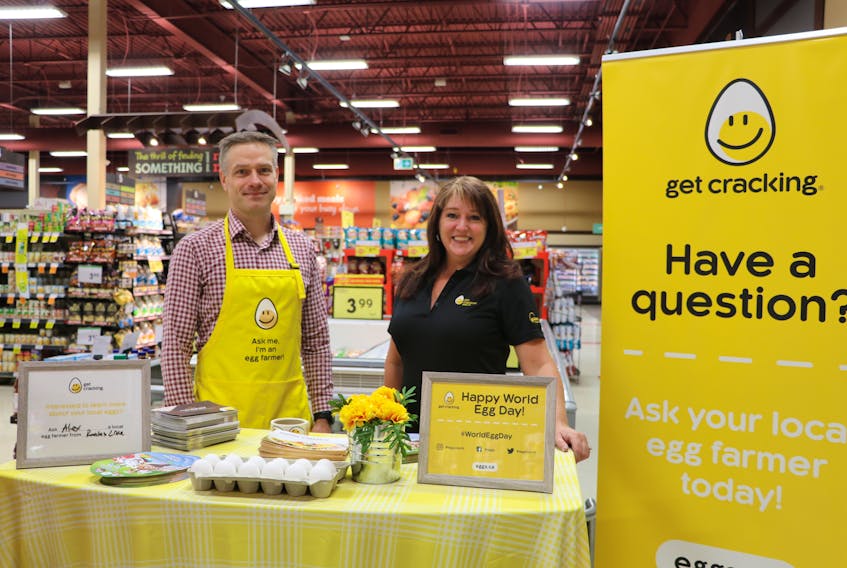 Egg farmer Alex Smallwood of Russwood Poultry on Roaches Line and Kelly Baggs, office manager of the Egg Farmers of Newfoundland and Labrador, talk to customers at Sobeys in Paradise Friday about the benefits of eating eggs that are produced locally.