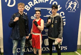 Bothers Seamus (left) and Riley O’Brien of the TRC  Boxing Club in St. John’s flank Michael Gosine of the Conception Bay South Boxing Club as they pose for a picture during the Brampton Cup boxing tournament in Brampton, Ont., over the weekend. — Submitted