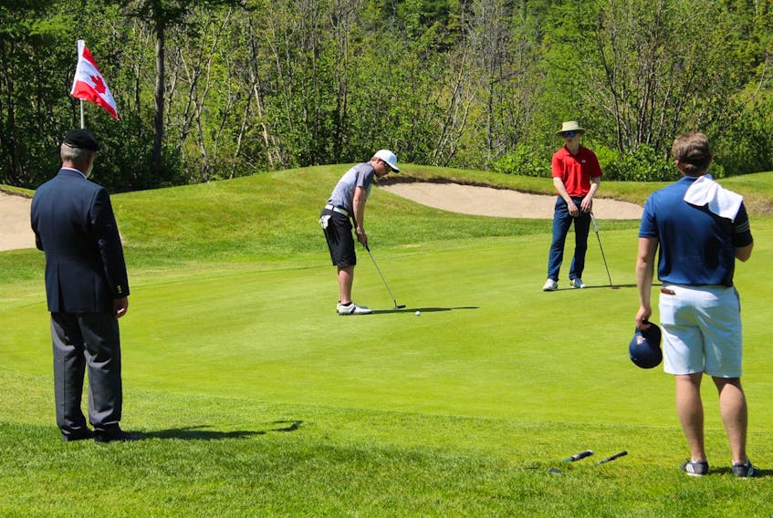 Matt Bonnell makes a putt on the final hole on his way to winning the provincial junior men’s golf championship Wednesday at the Terra Nova Resort and Golf Community in Port Blandford.  Lloyd Clarke, a Canadian veteran who served in Afghanistan, was the flagbearer on the 18th hole during the final round. — Golf NL/Facebook