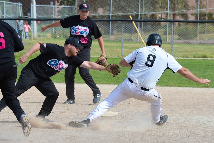 Jon Kelly (right) of the Kelly’s Pub Bulldogs works to avoid being tagged by the 3 Cheers Pub Bud Light Dodgers’ Kyle Ezekiel as he scampers to second base during Sunday’s final of the Molson provincial senior men’s softball championship at Lions Park in St. John’s. Kelly was eventually called out on the play.