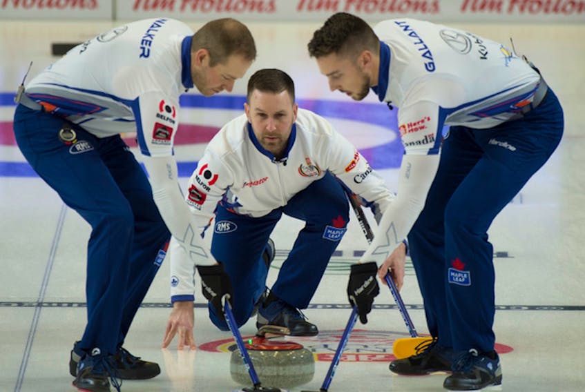 Brad Gushue puts a shot into the hands of sweepers Geoff Walker (left) and Brett Gallant (right) during play at the Canada Cup of Curling in Estevan, Sask. — Curling Canada photo/Michael Burns
