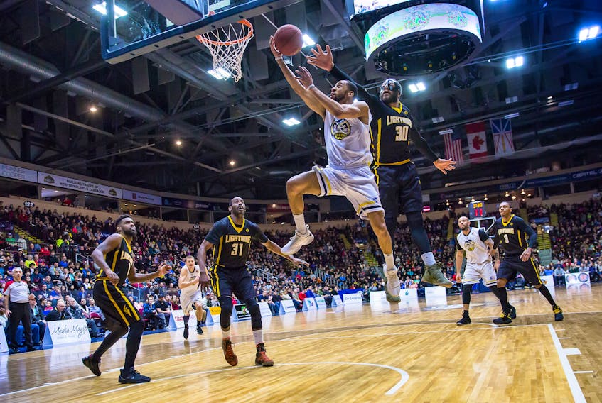 Coron Williams of the St. John's Edge goes up to the basket as Royce White (30) of the London Lightning tries to defend during their National Basketball League of Canada game at Mile One Centre Sunday. After dropping a 110-108 decision to the Edge Saturday night, the Lightning responded with a 124-102 victory in the rematch. — St. John's Edge photo/Jeff Parsons