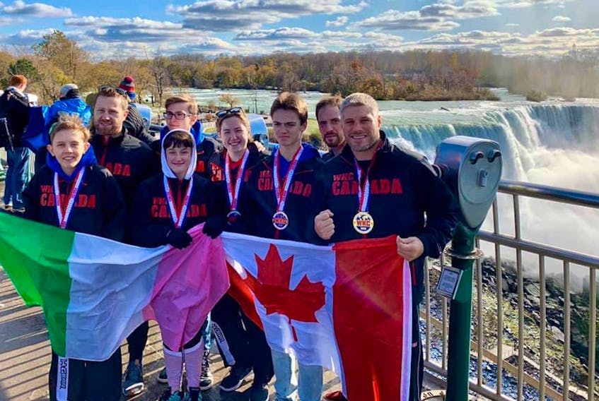 Members of Newfoundland's Rock Athletics club pose with flags and medals after the 2019 World Karate and Kickboxing Commission’s (WKC) 2019 word championships in Niagara Falls, N.Y. — Submitted