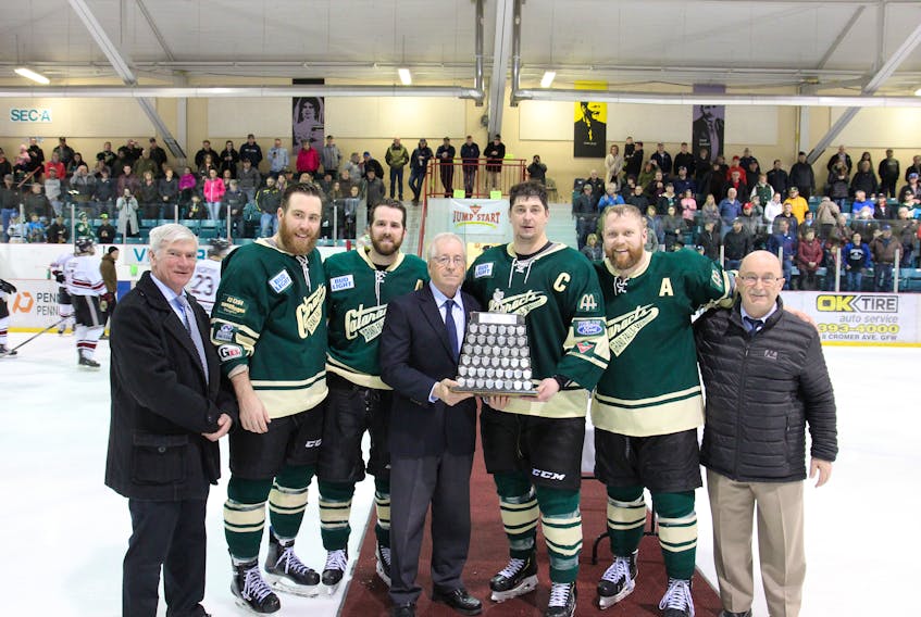Rod Bennett/Action Sports Shots — The Grand Falls-Windsor Cataracts won the 2019 Herder Memorial Trophy championship Sunday with a 3-2 overtime win over the Southern Shore Breakers. On hand for the presentation of the Herder were, from left, Mike Gorman (son of Cliff Gorman, for whom the Herder playoff MVP award is named), Rodi Short, Andre Gill, provincial senior hockey chairman Gary Gale, Cataracts captain and Cliff Gorman Award winner Michael Brent, Sam Hounsell and Joe Maynard, the Eastern Arena director for senior hockey.