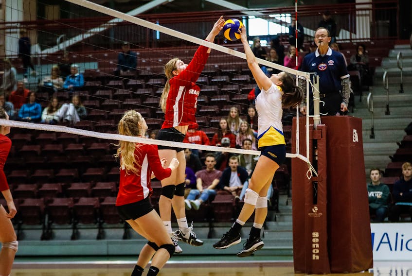 Memorial’s Alyssa Warford (2), shown competing for a ball at the net in an AUS women’s volleyball game against Moncton at the Field House in St. John’s last weekend, is second in the conference in total points. — Memorial Athletics/Allison Wragg