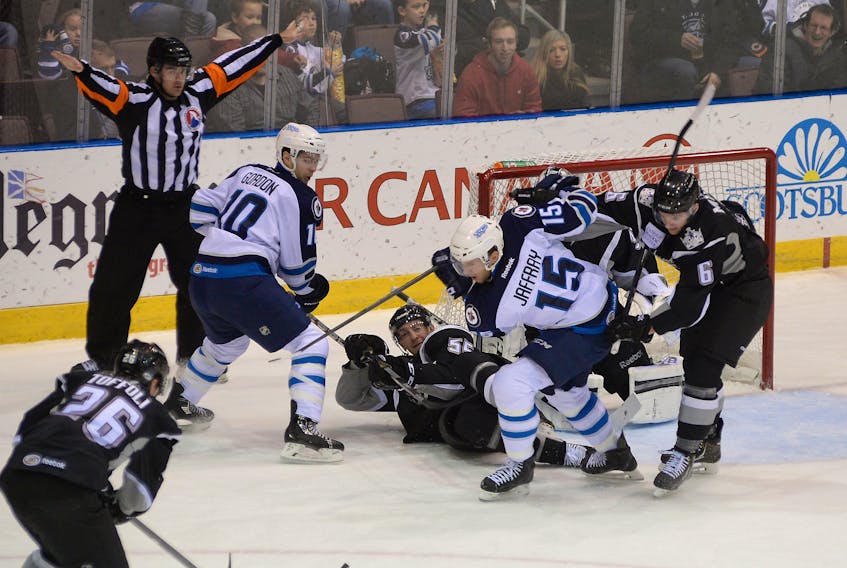 In this file photo, St. John’s IceCaps forwards Andrew Gordon and Jason Jaffray hunt down a loose puck in front of the Manchester Monarchs’ goal as Monarchs Tyler Toffoli, Jeff Schultz (55) and Colin Miller (6) look on. The IceCaps, and the AHL’s St. John’s Maple Leafs before them, had to deal with higher-than-normal travel costs, and not just for themselves. They also paid a travel subsidy to visiting teams like Manchester. The Monarchs will have their plane travel costs to St. John’s covered again in 2018-19, but this time as a member of the ECHL as they come here to take on the league’s newest entry, the Newfoundland Growlers. — Telegram file photo/Keith Gosse