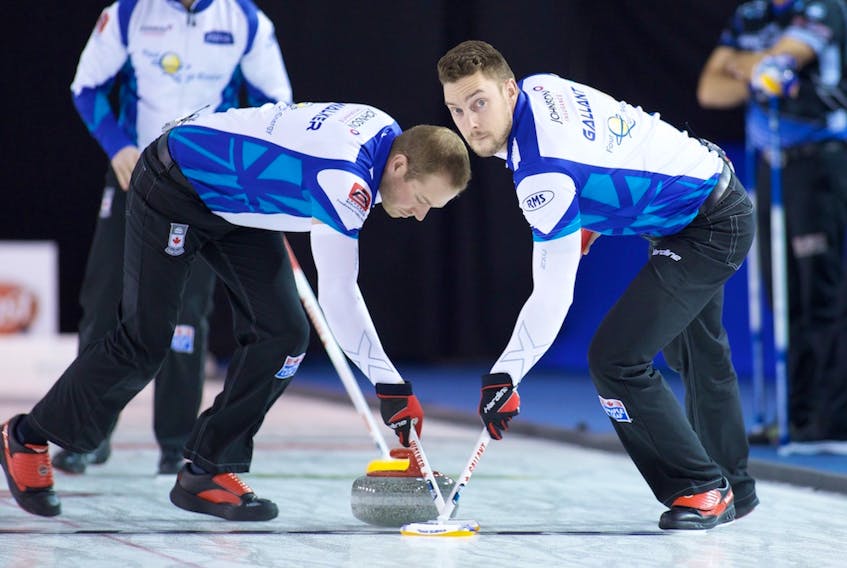 Geoff Walker and Brett Gallant (right) sweep a rock during the Elite 10 Grand Slam of Curling event earlier this month in Winnipeg. Gallant is the second member of Brad Gushue’s curling rink dealing with the death of a close relative this week as the team prepares for the world men’s curling championship in Las Vegas. Gallant’s maternal grandfather, Lorn Burke, died Tuesday in P.E.I. just three days after third Mark Nichols mother passed away.