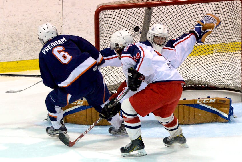 Stephen Predham of the Mount Pearl Blades scores on CBR Renegades goaltender Shawn Hurley during Game 5 of the St. John’s Junior Hockey League final at the Mount Pearl Glacier Sunday evening. Trailing the play is the Renegades’ Drew Stonehouse. The Blades won 5-1 to take the SJJHL crown.