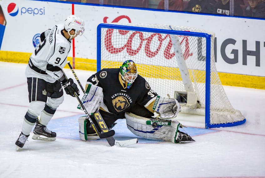 Newfoundland Growlers goaltender Michael Garteig stops the Manchester Monarchs’ Sam Kurker from in close during ECHL action at Mile One Centre Saturday night. It was one of 44 saves made by Garteig in a 3-0 shutout victory. — Newfoundland Growlers photo/Jeff Parsons
