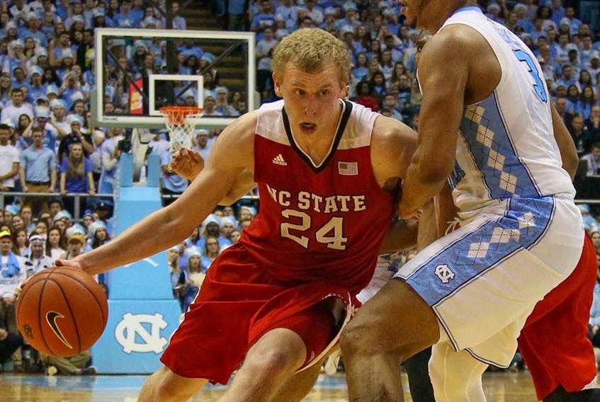 Maverick Rowan (24), shown in a game against the University of North Carolina, averaged more than 12 points over two seasons with the NC State Wolfpack. — NC State Athletics