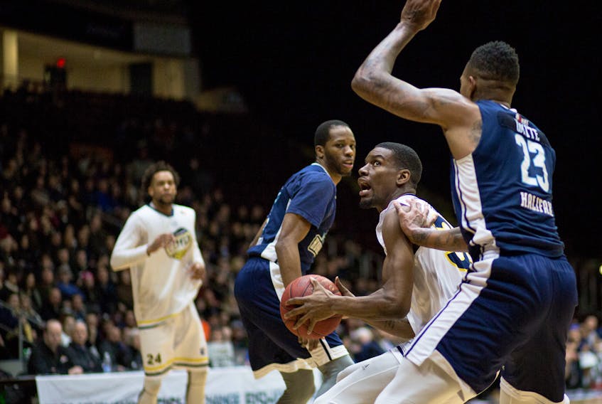 St. John's Edge forward Xavier Ford looks to go to the basket as Billy White (23) of the Halifax Hurricanes guards him during their National Basketball League of Canada game at Mile One Centre Wednesday night.  Ford had 25 points and nine rebounds as St. John's won 108-97. — St. John's Edge photo/Jeff Parsons