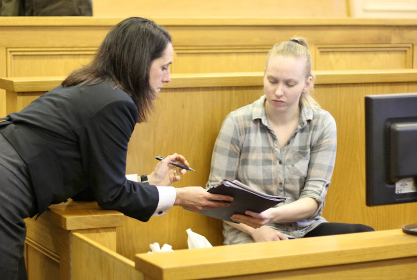 Defence lawyer Rosellen Sullivan (left) discusses evidence with Anne Norris, 30, after the first week of Norris’ murder trial wrapped up at Newfoundland and Labrador Supreme Court Friday afternoon.