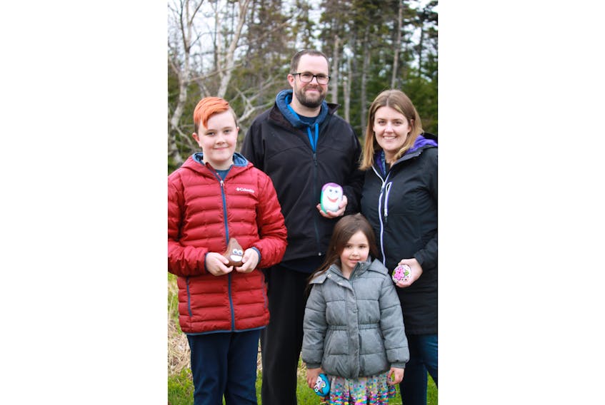 The Dawe family (from left) Alex, Bradley, Elizabeth and Kelli, left some more painted rocks at the Virginia River Trail in St. John’s on Friday. — Jasmine Burt/Special to The Telegram
