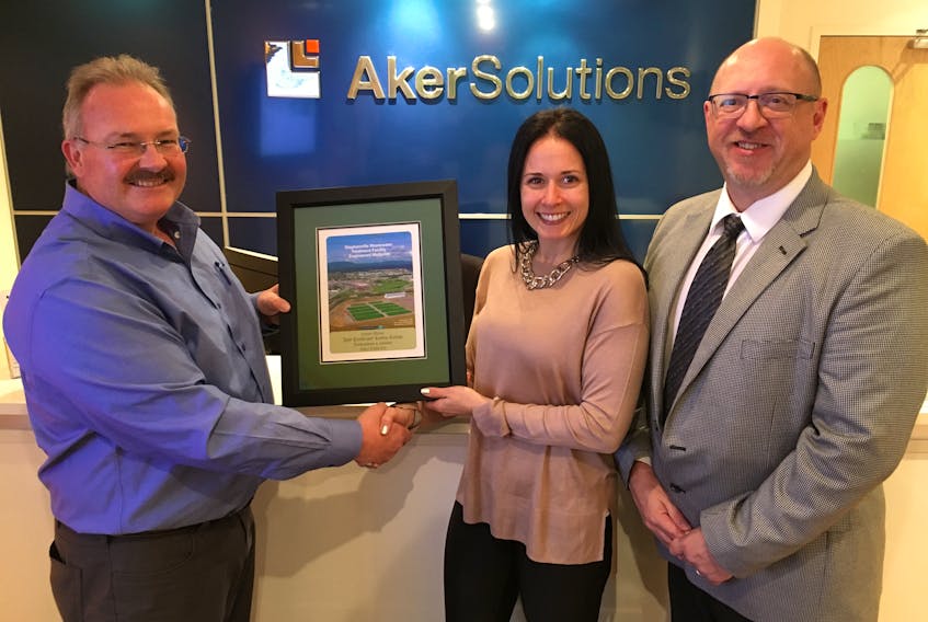 Glenn Sharp (left) presents an official Newfoundland Climate and Ecosystems Conservancy Project carbon credit to Aker Solutions Canada HSE manager Melissa English-Barbour and vice-president and general manager Dave Billard.