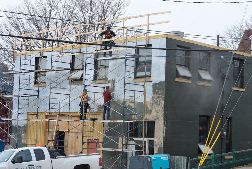 Workers renovate the former East End Fire Station on the corner of Duckworth Street and Ordnance Street on Wednesday.