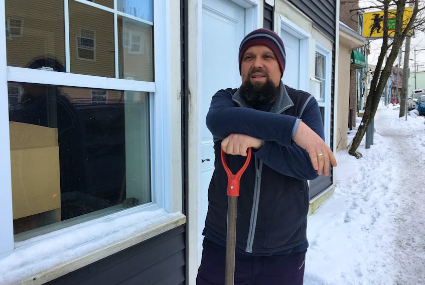 Eldin Husic takes a break from shovelling the walkway in front of the new location he and his wife, Adnela Halebic-Husic, have secured to be the home of the Balkan Kitchen, an ethnic restaurant serving cuisine using recipes from their native Bosnia and Herzegovina.