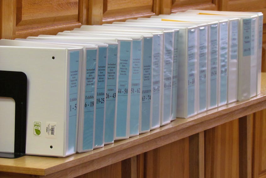 Binders filled with documents for the Public Utilities Board (PUB) review of provincial power options are seen in the PUB hearing room at the Prince Charles Building in St. John's.
