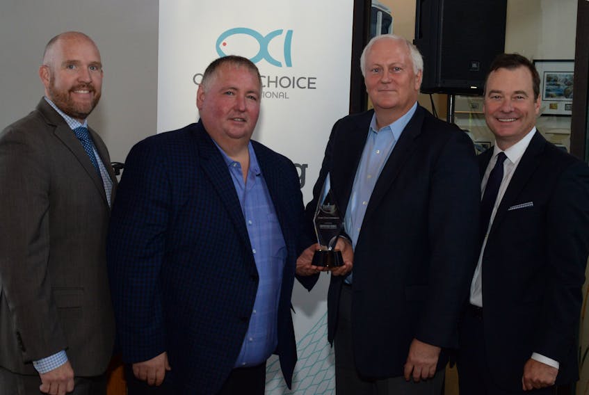 Accepting their award from sponsor partner Chris King (left) of the law firm McInnes Cooper and NLEC executive director Richard Alexander (right) are OCI owners/operators Blain Sullivan (second from left) and Martin Sullivan.