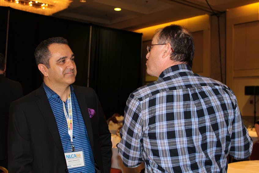 Mark Casaletto (left), president of Construction Market Data – Canada, discusses a variety of issues with Robert Curtis of Deer Lake at the  50th anniversary conference of the Newfoundland and Labrador Construction Association at the Delta Hotel in St. John’s on Friday.