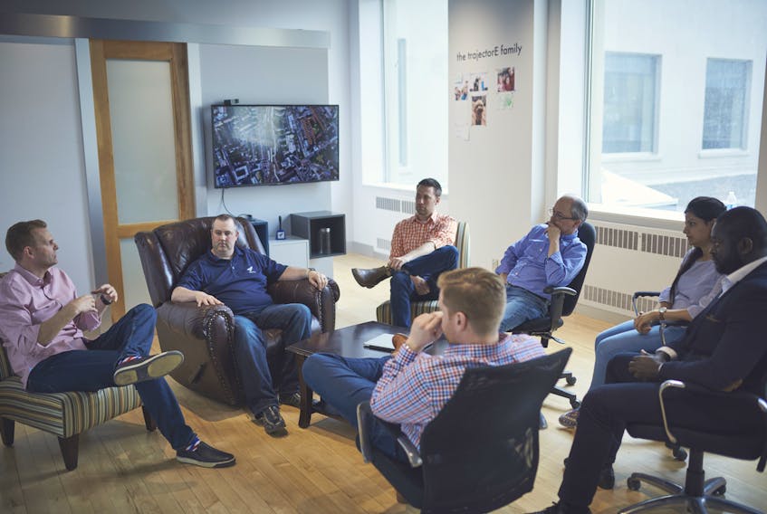 CEO Andrew Sinclair (far left) leads the trajectorE and totaliQ teams in a combined staff meeting at their offices in downtown St. John’s. totaliQ lauched an early version of its intelligent knowledge sharing solution earlier this month and are now in the market for to attract some early adopters to help refine the model and thereby strengthen the artificial intelligence that sets it apart from peers in the lessons-learned database world.