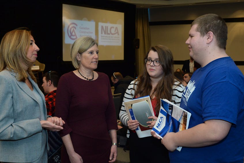 (From left) Zey Emir of Montreal, chair of the Canadian Construction Association (CCA), and CCA president Mary Van Buren of Ottawa chats Thursday with post-secondary students Kelsey Kent, a civil engineering student at MUN, and Joseph Boyd, a Construction Industrial Technician (electrician) at Academy Canada in St. John’s.