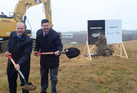 Jeff Ryan (left), vice-president of government and stakeholder relations with Canopy Growth Corp., and Industry Minister Chris Mitchelmore toss scoops of dirt after breaking ground at the future site of Canopy’s production headquarters for the province on Eastland Drive in the White Hills in St. John’s.
