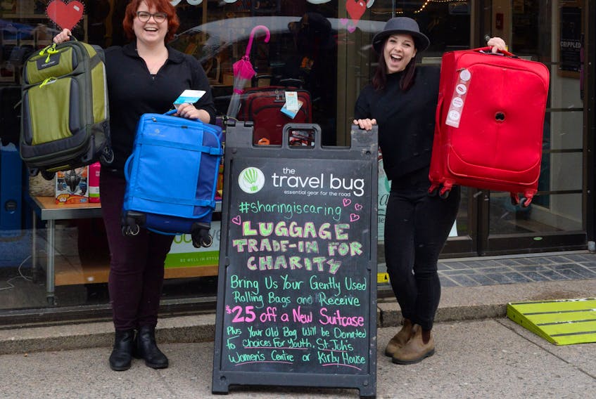 Travel Bug employees Katrina Taliana (left), store manager, and sales associate Diana Lono with pieces of luggage outside the Water Street retail outlet on Friday morning.