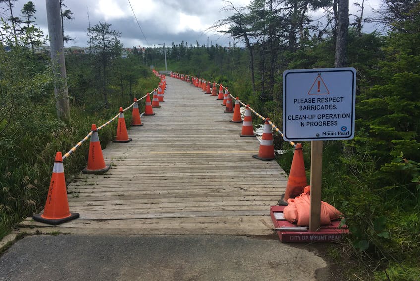 The Power’s Pond walking trail was closed for more than a month during the summer of 2018. After an initial clean-up effort, absorbent pads and booms — visible in these file photos — remained along the boardwalk and were monitored daily, to continuing capture the oil contaminating the marsh running between the city’s industrial area and the popular local pond. Oil-stained boardwalk planks have been identified for replacement later this year.